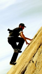A person climbing a steep rock face
